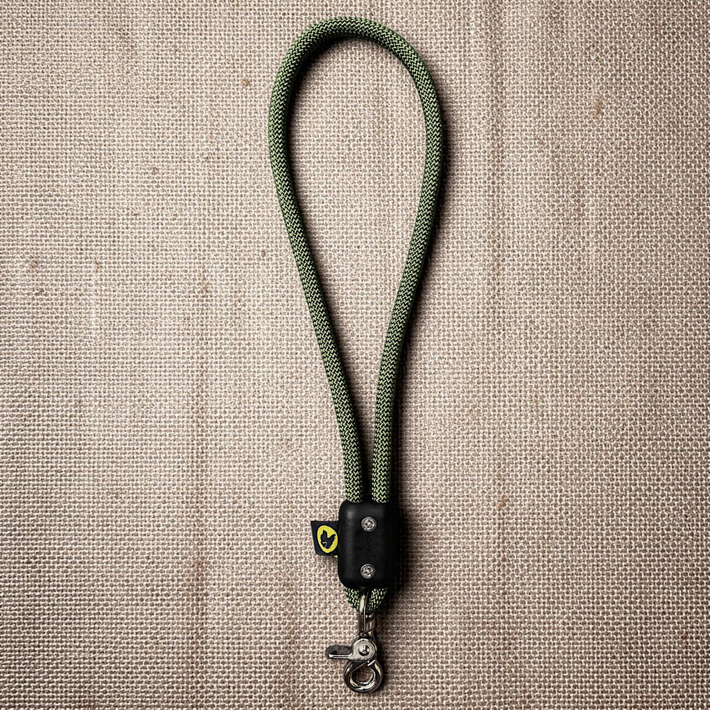 Green traffic handle short dog leash with a stainless steel clip on a burlap cloth