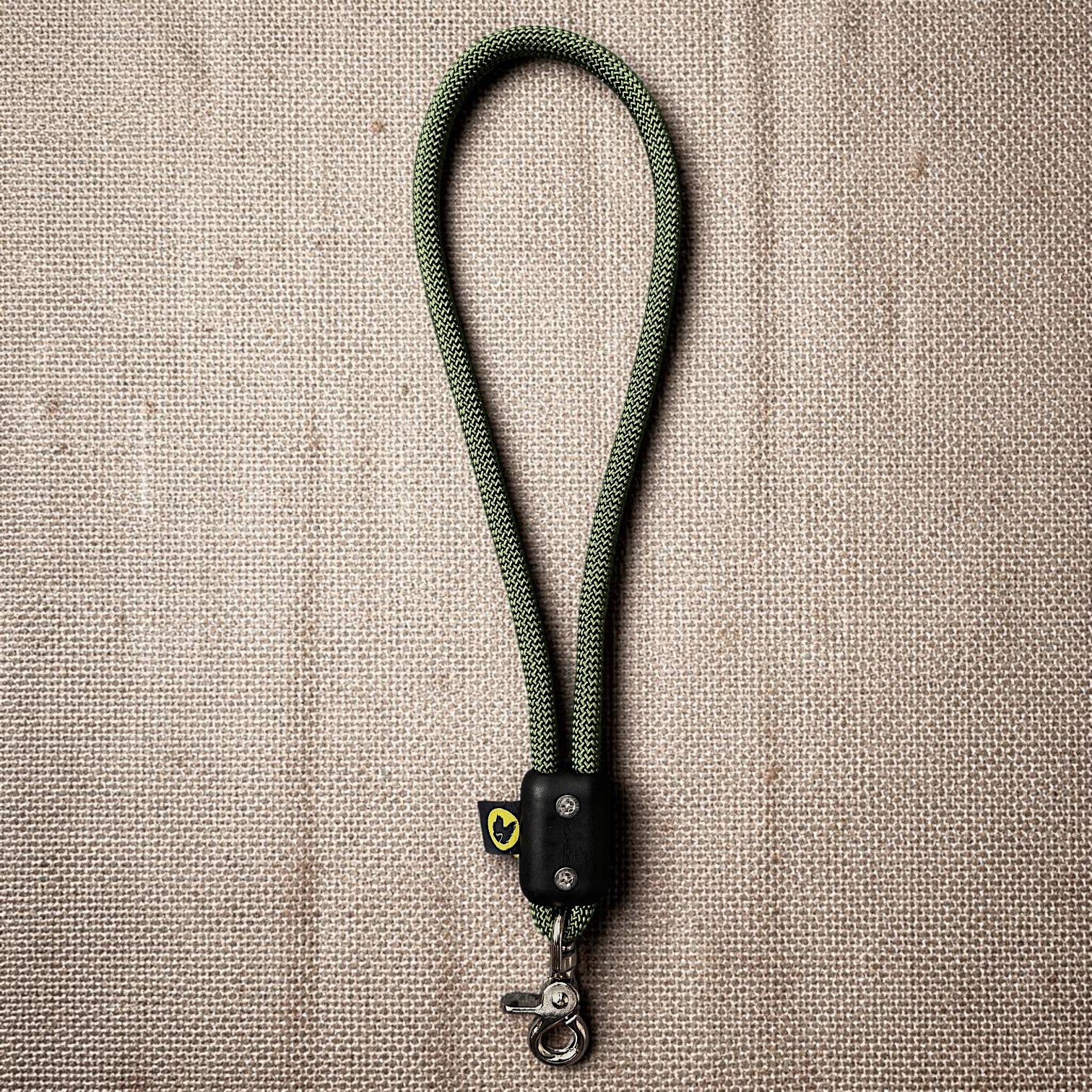 Green traffic handle short dog leash with a stainless steel clip on a burlap cloth