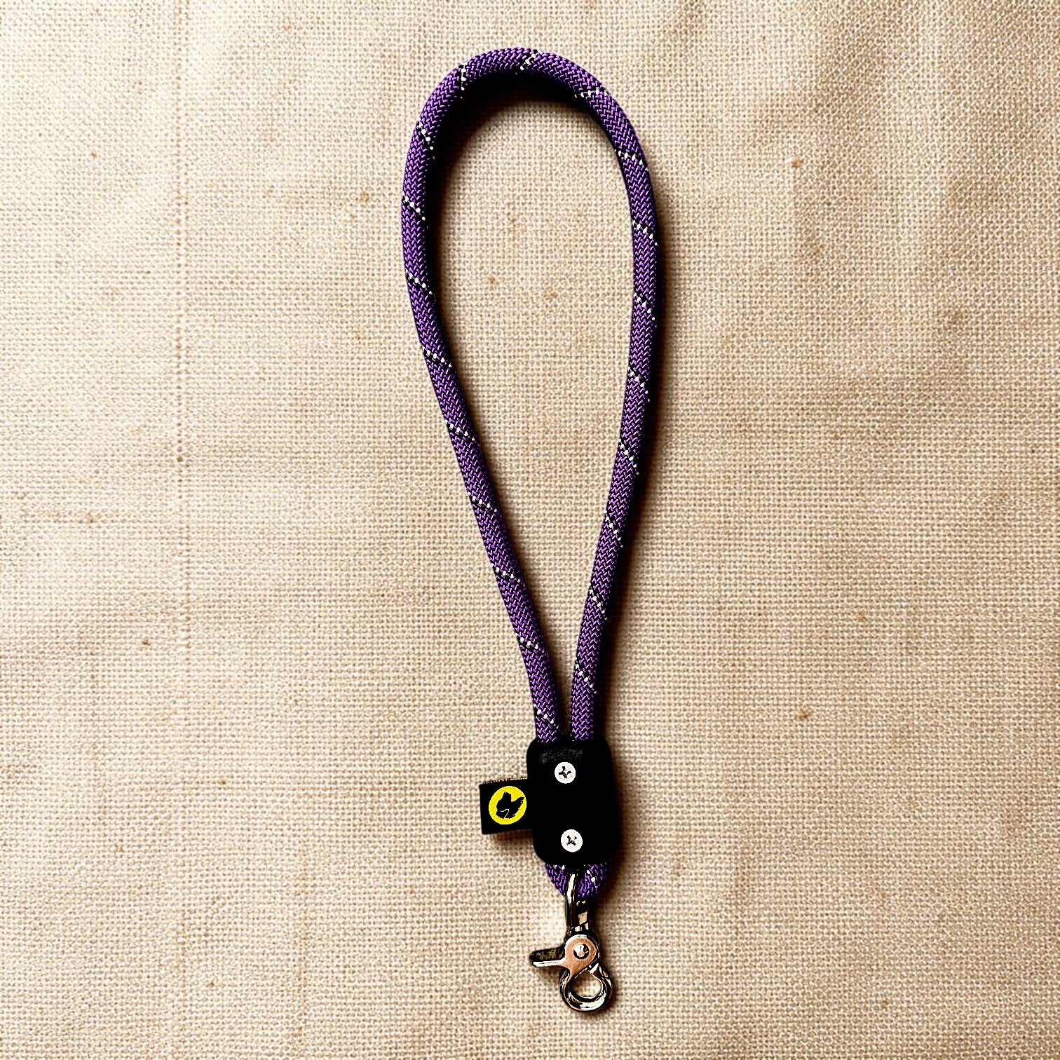 Red traffic handle loop short dog leash with a stainless steel clip on a burlap cloth